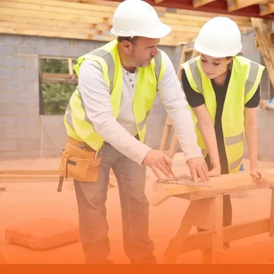 Mentor and student construction workers